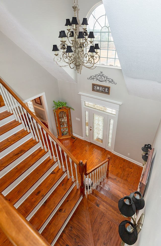 entryway with a chandelier and wood-type flooring