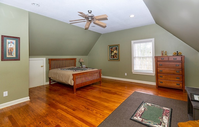 bedroom featuring ceiling fan, hardwood / wood-style floors, and lofted ceiling