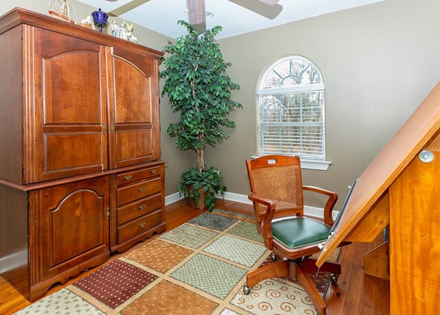 living area featuring a textured ceiling and hardwood / wood-style flooring