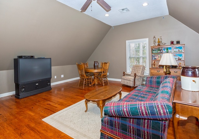 living room featuring hardwood / wood-style floors, ceiling fan, and lofted ceiling