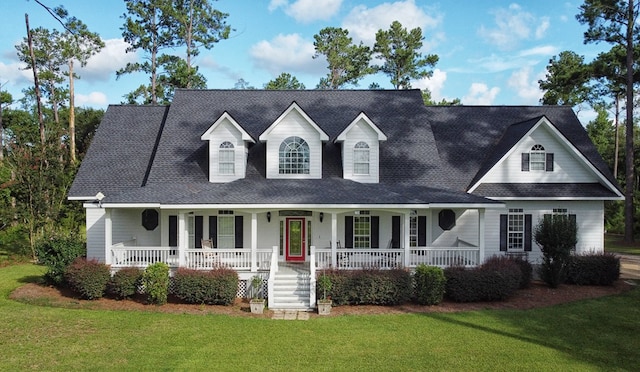 cape cod home featuring covered porch and a front lawn