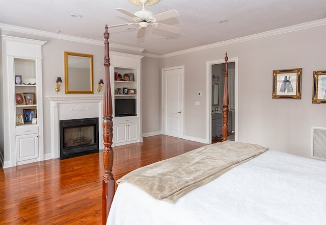 bedroom with ceiling fan, crown molding, dark wood-type flooring, and a textured ceiling