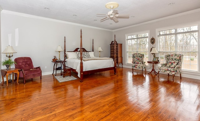 bedroom featuring multiple windows, ceiling fan, crown molding, and hardwood / wood-style flooring