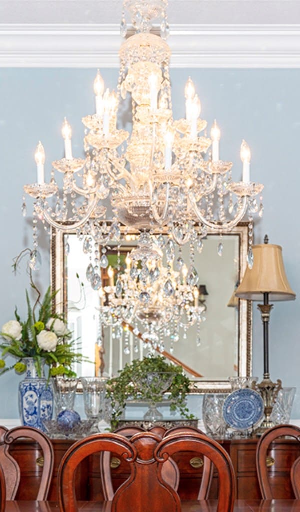 interior details featuring a chandelier and crown molding