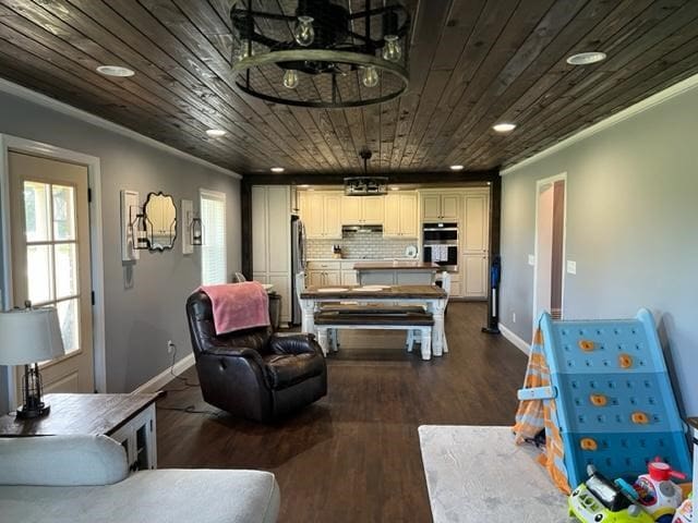 1104 Old Thomasville Rd, Cairo, GA 39828 - living area featuring ornamental molding, dark wood-style flooring, healthy amount of natural light, and wooden ceiling