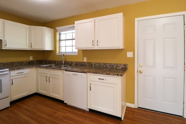 kitchen featuring dark countertops, a sink, white appliances, white cabinetry, and dark wood-style flooring