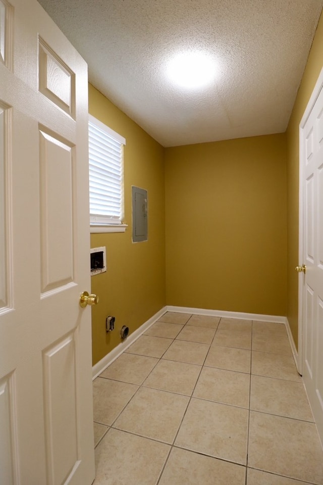 clothes washing area featuring washer hookup, electric panel, hookup for a gas dryer, light tile patterned floors, and laundry area