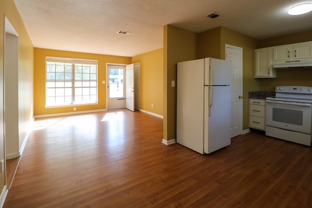 kitchen with under cabinet range hood, white appliances, dark wood-style flooring, and white cabinetry