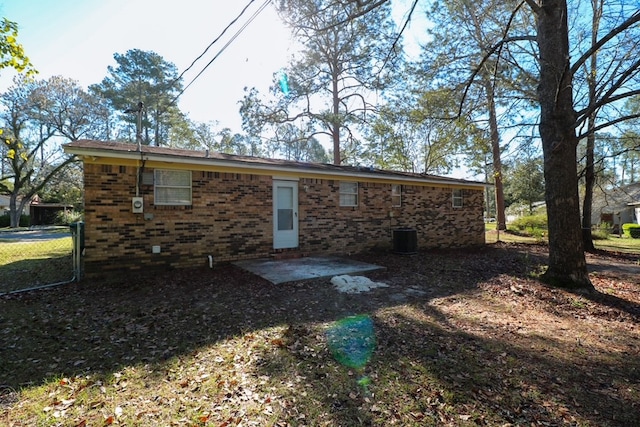 rear view of property with a patio and brick siding