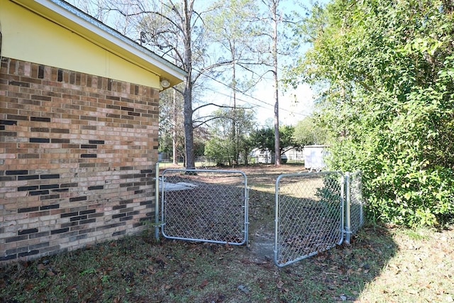 view of yard featuring fence and a gate