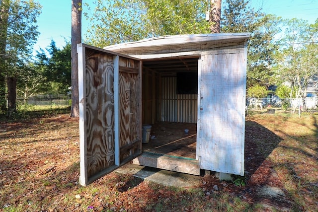 view of shed featuring fence