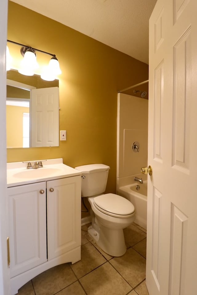 full bathroom with tile patterned flooring, toilet, vanity, and washtub / shower combination