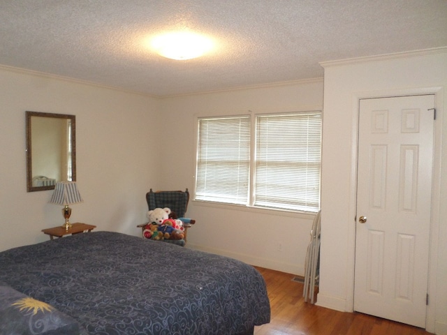 701 Collier St, Bainbridge, GA 39819 - bedroom with ornamental molding, wood finished floors, and a textured ceiling