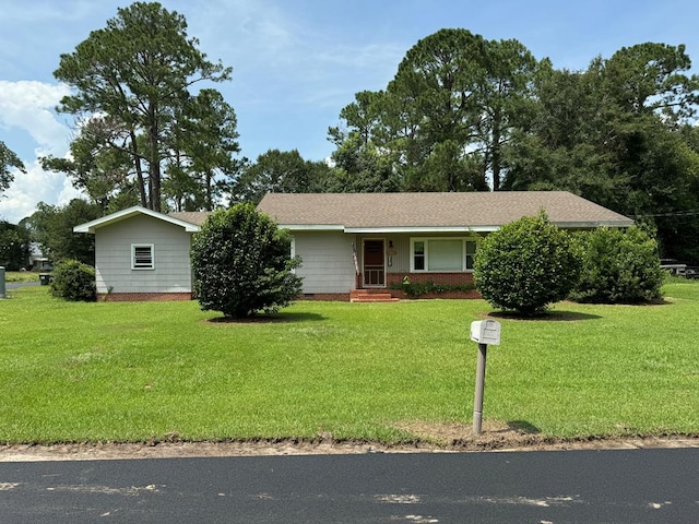 ranch-style house featuring a porch and a front lawn