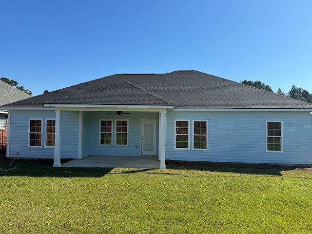 back of property featuring a lawn, ceiling fan, and a patio