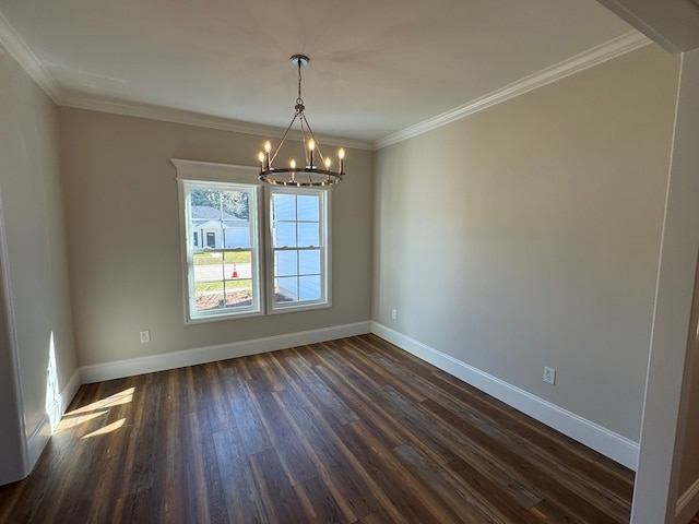 empty room with a notable chandelier, dark hardwood / wood-style flooring, and crown molding