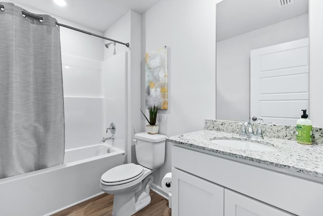 full bath featuring toilet, shower / tub combo, wood finished floors, visible vents, and vanity