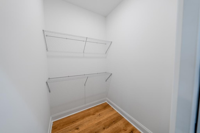 walk in closet featuring attic access and light wood-type flooring