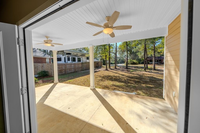 view of patio with a ceiling fan and fence