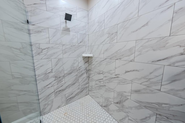 bathroom with a tile shower