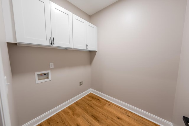 laundry area with washer hookup, cabinet space, light wood-style flooring, hookup for an electric dryer, and baseboards