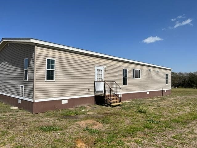 rear view of property featuring crawl space