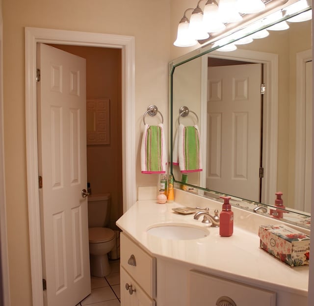 bathroom featuring vanity, tile patterned floors, and toilet