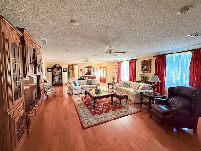 living room with visible vents, plenty of natural light, and wood finished floors