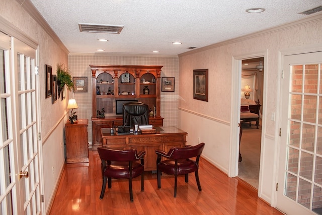 office space featuring visible vents, wallpapered walls, and ornamental molding