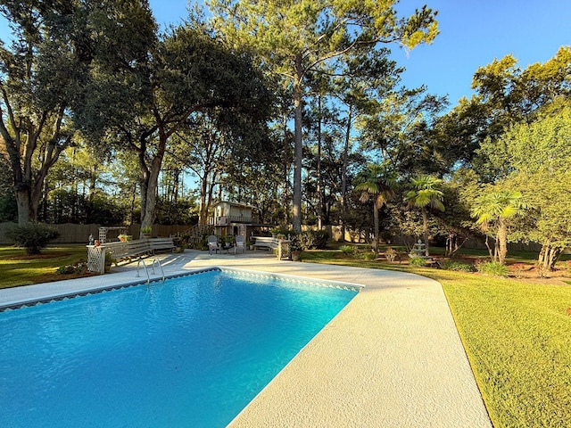 outdoor pool featuring a yard, a patio, and fence