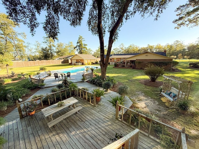 deck with a fenced in pool, a yard, and fence