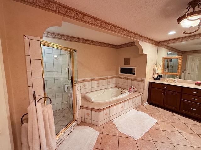 full bathroom featuring vanity, tile patterned flooring, a textured ceiling, crown molding, and a bath