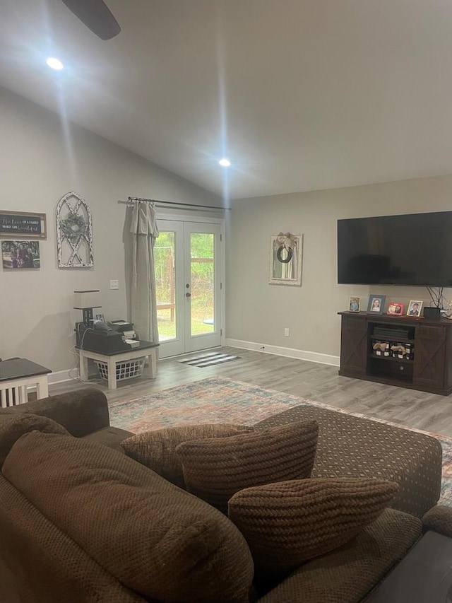 living area with wood finished floors, recessed lighting, french doors, baseboards, and vaulted ceiling