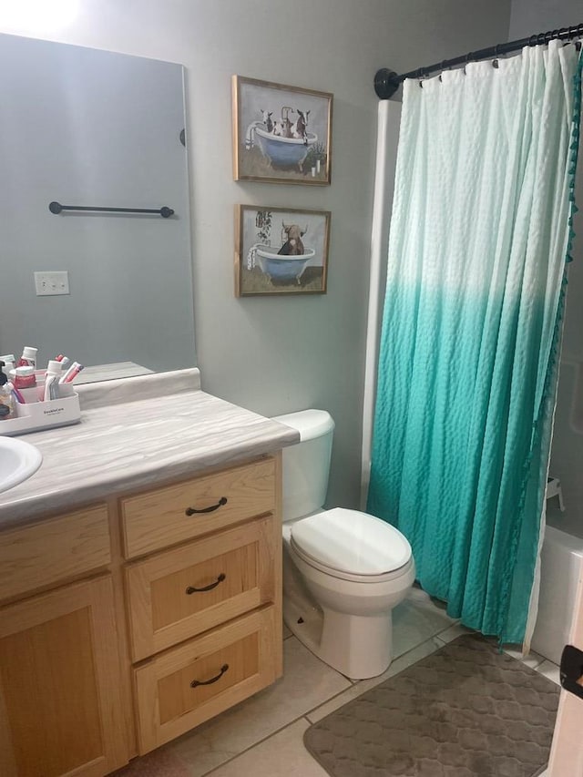 bathroom with tile patterned floors, toilet, and vanity