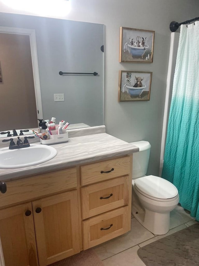 full bath featuring curtained shower, toilet, vanity, and tile patterned flooring