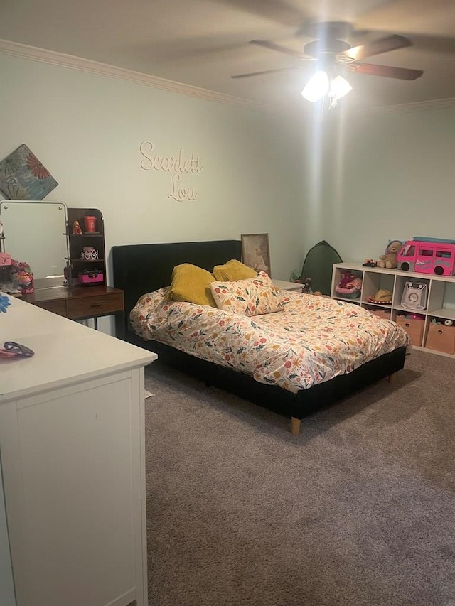 carpeted bedroom with ceiling fan and ornamental molding