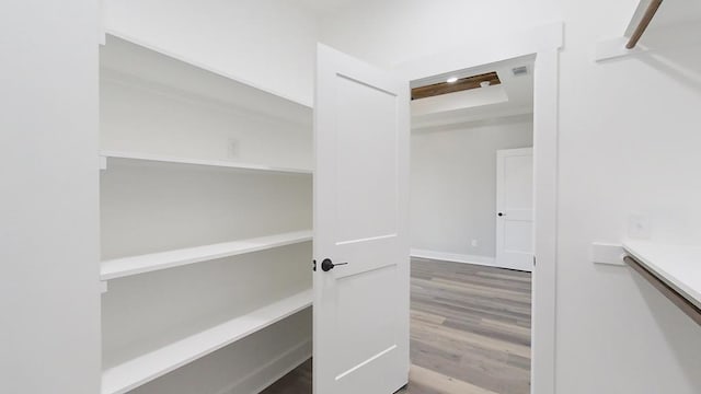 spacious closet featuring hardwood / wood-style flooring