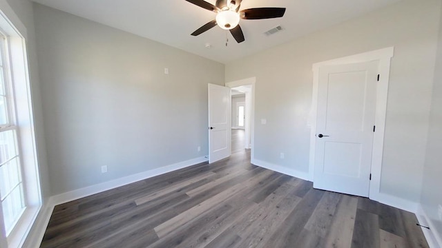 unfurnished bedroom with dark hardwood / wood-style floors and ceiling fan