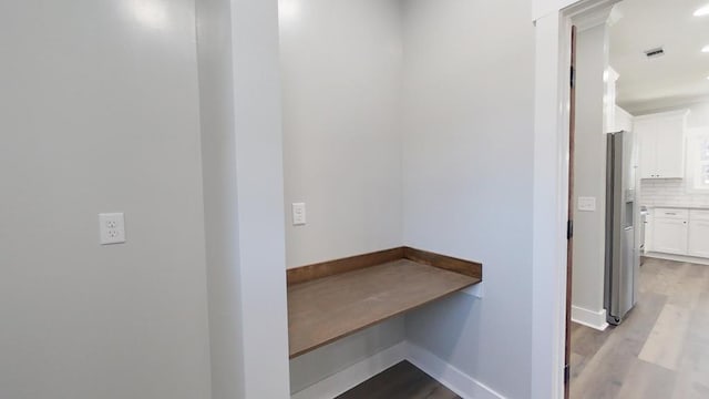 hallway with light hardwood / wood-style floors