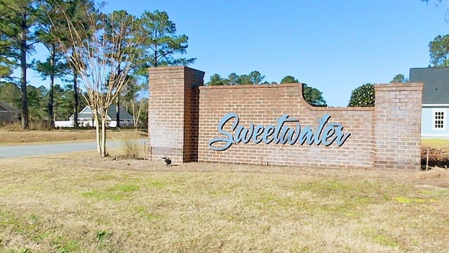 community / neighborhood sign with a yard