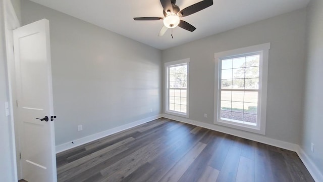 unfurnished room featuring dark wood-type flooring and ceiling fan