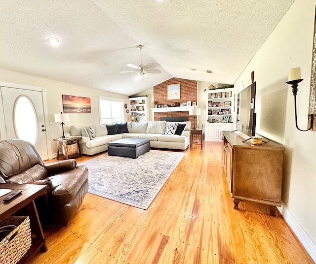 living room with hardwood / wood-style floors, a textured ceiling, vaulted ceiling, and ceiling fan