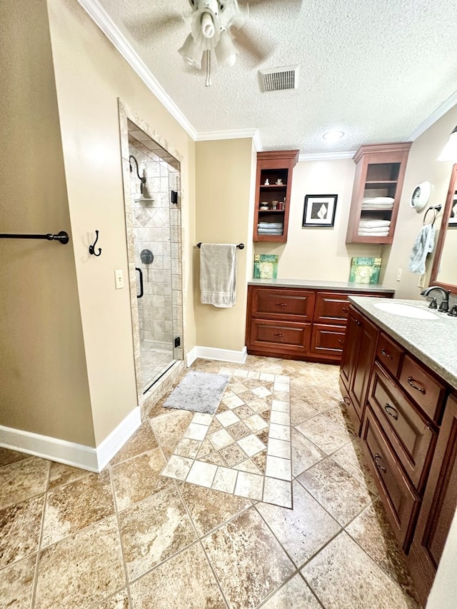 bathroom featuring walk in shower, ornamental molding, vanity, a textured ceiling, and ceiling fan