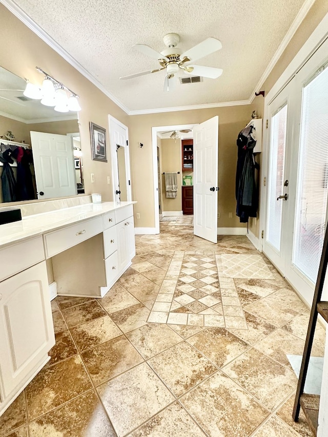 bathroom with crown molding, french doors, and a textured ceiling