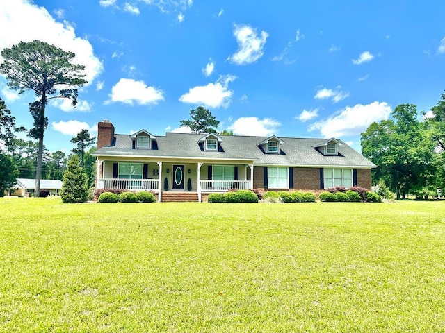 cape cod home featuring covered porch and a front lawn