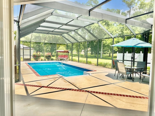 view of swimming pool with a lanai and a patio area