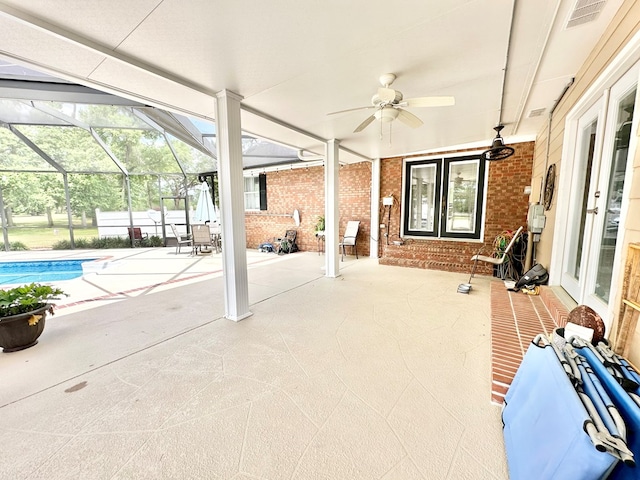 exterior space featuring glass enclosure and ceiling fan