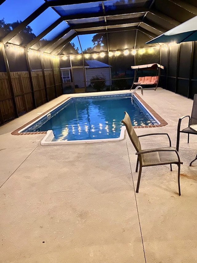 view of pool with a lanai and a patio