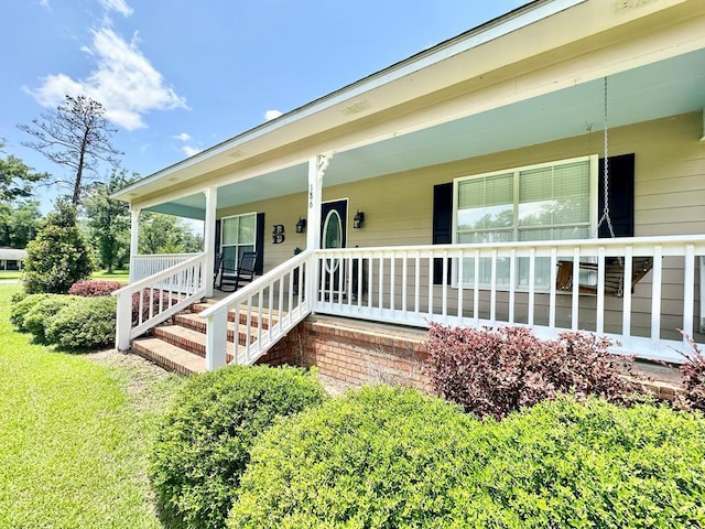 view of exterior entry with a porch