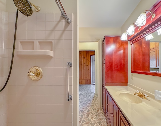 bathroom with vanity and tiled shower